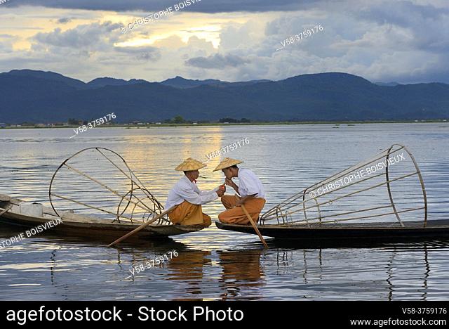 Myanmar, Shan State, Inle Lake, Intha fishermen lighting a cigar