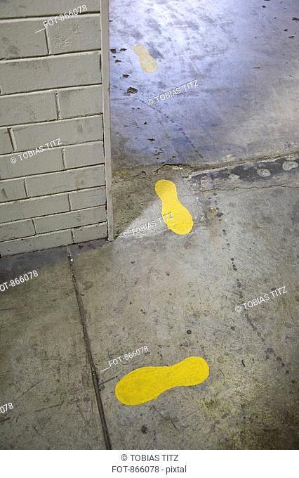 Painted footprints on a concrete pathway