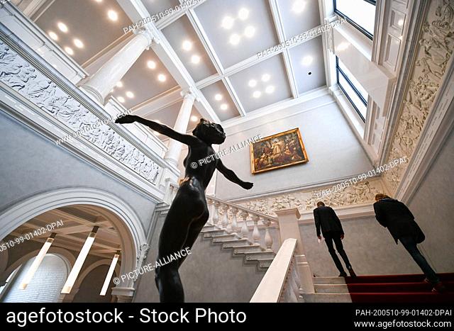 07 May 2020, Berlin: Employees walk up a staircase in the closed Alte Nationalgalerie. On Tuesday, the Old National Gallery, the Old Museum