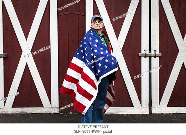 Senior man wearing American flag, portrait