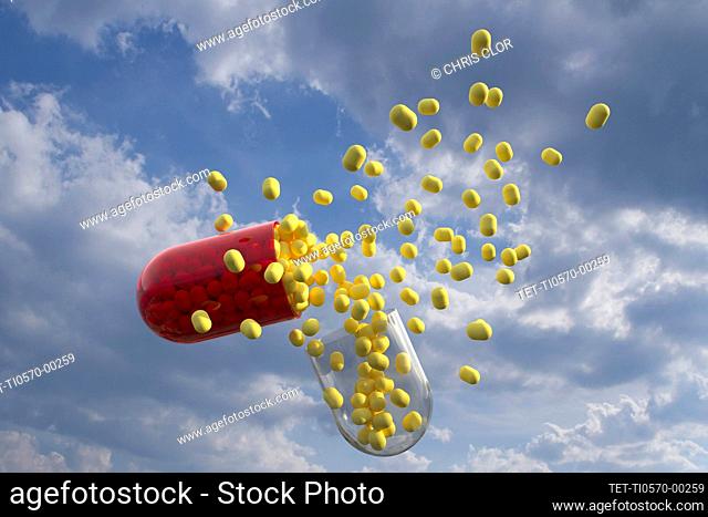 Capsule with yellow pills inside with clouds as background