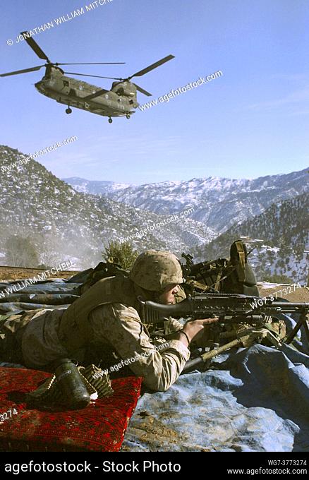 AFGHANISTAN Korengal Valley -- 29 Jan 2005 -- A US Marine Corps machine gunner of Lima Company, Josh Ploetz, looks over the sights of his M-240G machine gun as...