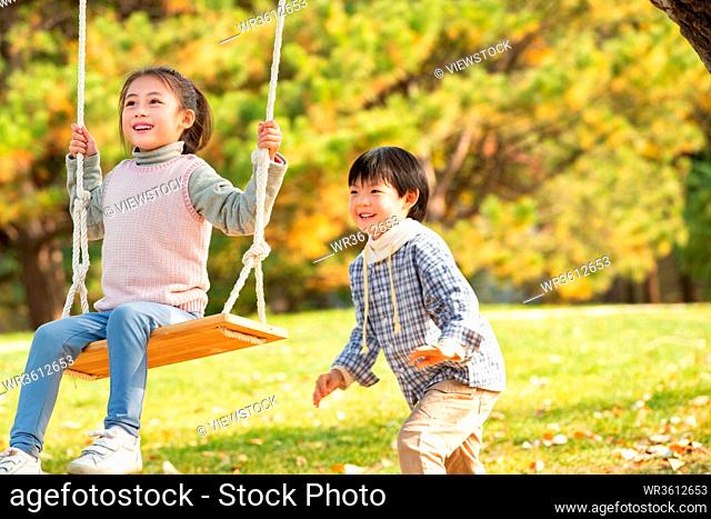 Happy children's swing in the park