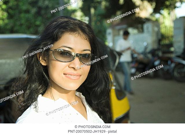 Young woman wearing sunglasses and smiling