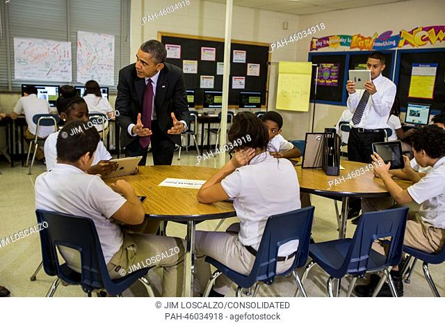 United States President Barack Obama tours a seventh grade classroom that uses technology to enhance students' learning experience