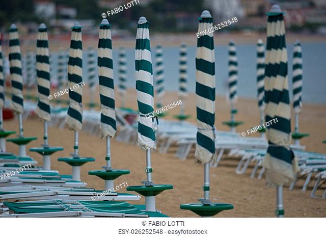 Row of beach umbrellas in a beach resort of Marcelli di Numana in Marche