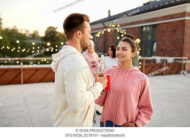 friends with non alcoholic drinks at rooftop party