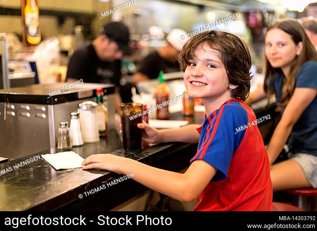 23 Street, New York City, NY, USA, Young boy and girl inside Eisenberg's Sandwich Shop - a well known classic New York sandwich shop