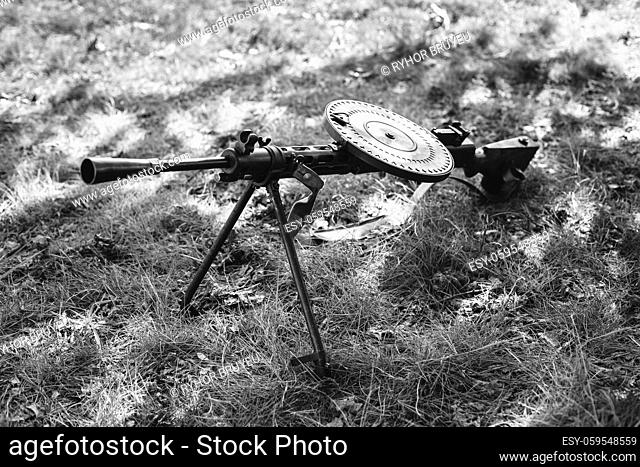 World War II Soviet Red Army Weapon. Degtyaryov DP Machine Gun On Ground. WWII WW2 Russian Ammunition. Photo In Black And White Colors
