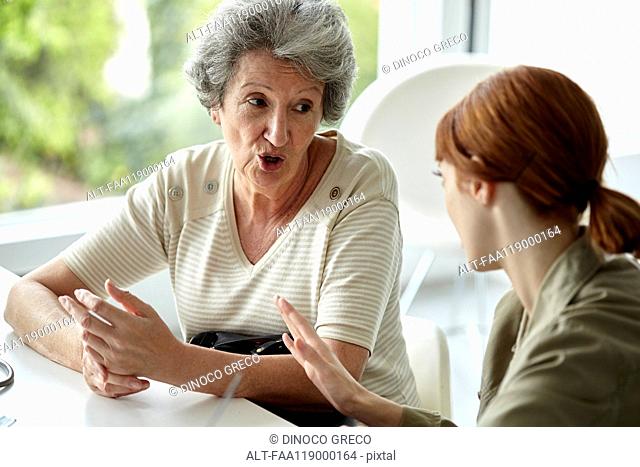 Senior patient talking with her daughter