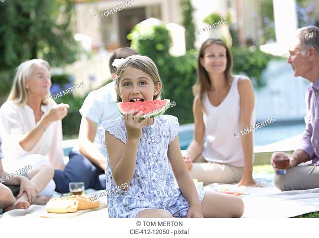 Girl eating watermelon at picnic