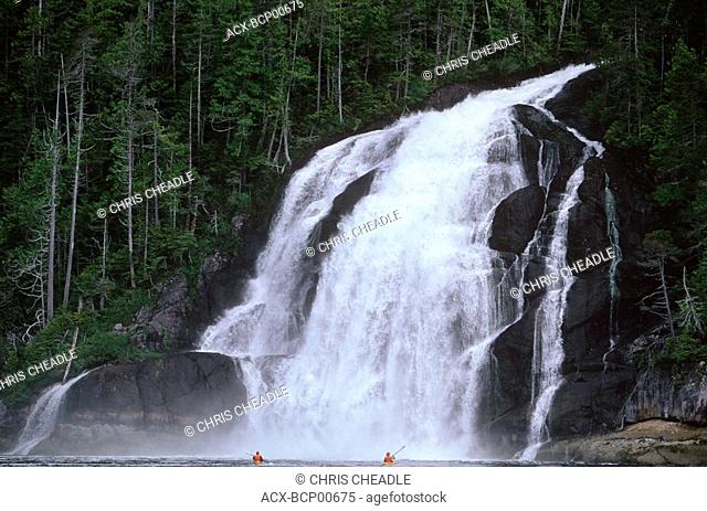 Fiordland Provincial Recreational Area , Kynoch Inlet waterfall with kayak paddlers, Central Coast, British Columbia, Canada