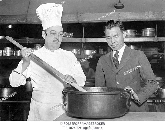 Historic photograph, cook stirring a pot with a large spoon