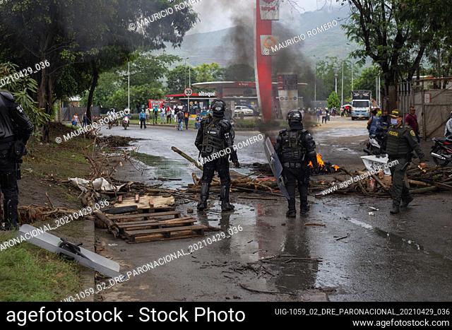 Riot Police (ESMAD) remove a barricade set on fire during the protesrs as demonstrators and Riot Police of Cali (ESMAD) clashed after the death of a...