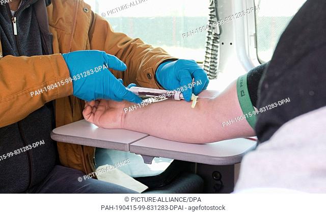 15 April 2019, Lower Saxony, Hannover: A doctor takes a blood sample from the Polish driver of a van at a rest stop on the A2 motorway after the urine sample...