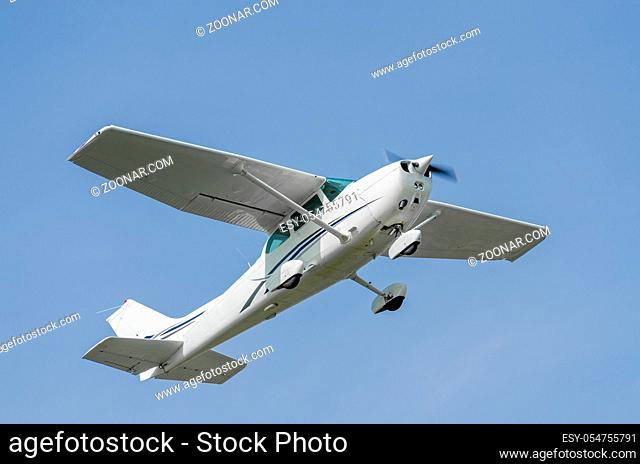 Single-engine sport airplane in a clear blue sky