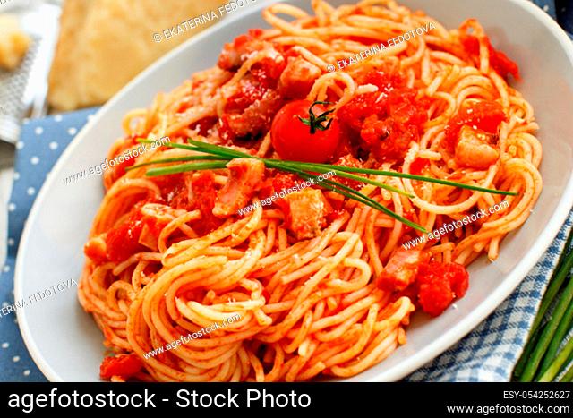 Spaghetti alla amatriciana on a wooden table top view