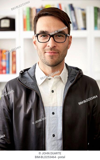 Portrait of smiling Caucasian man wearing jacket and eyeglasses