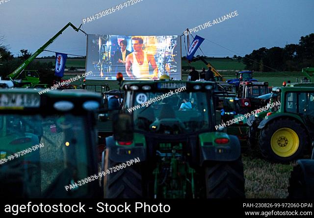 26 August 2023, Lower Saxony, Harsum: Numerous tractors are lined up on a field in the Harsumer Feldmark in front of a set-up screen