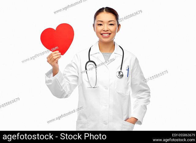 happy smiling asian female doctor with red heart