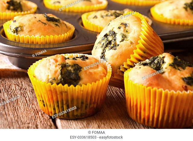 Snack muffins with spinach and feta cheese close-up on the table. horizontal