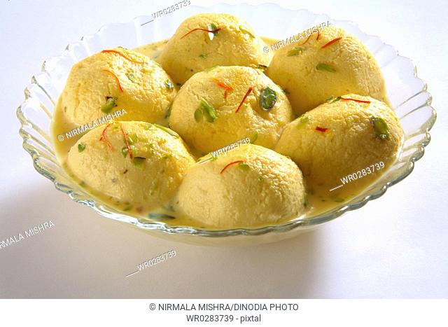 Indian sweet , kesar rasmalai garnish with pistachio and saffron served in bowl