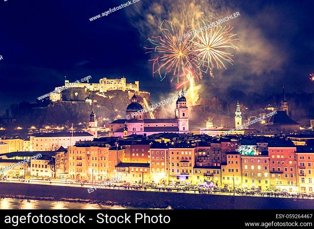 Colorful firework in the night: Old city of Salzburg and Festung Hohensalzburg at New Year’s Eve. Magic