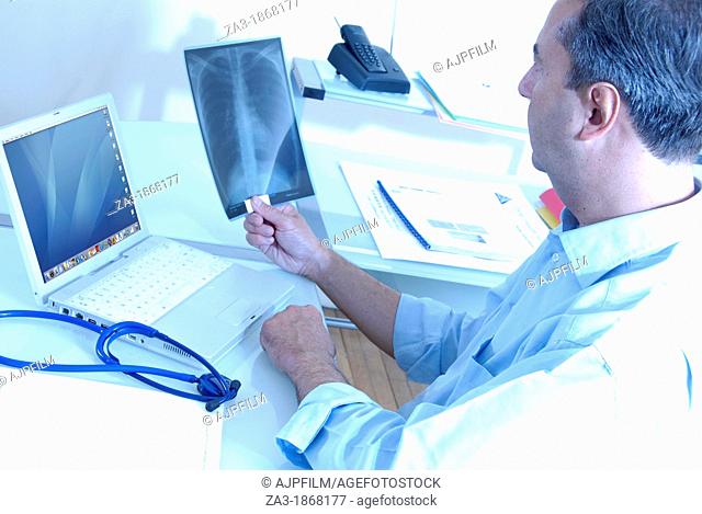 X-ray diagnosis  Doctor typing up the results of a patient's chest X-ray
