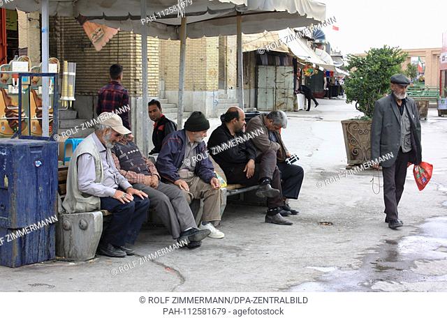 Iran - Scene with older men in a poorer neighborhood behind the Friday Mosque of Isfahan (Esfahan), capital of the province, on a Friday off work