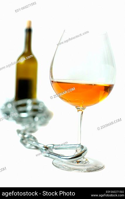 Glass with wine attached by chain to bottle