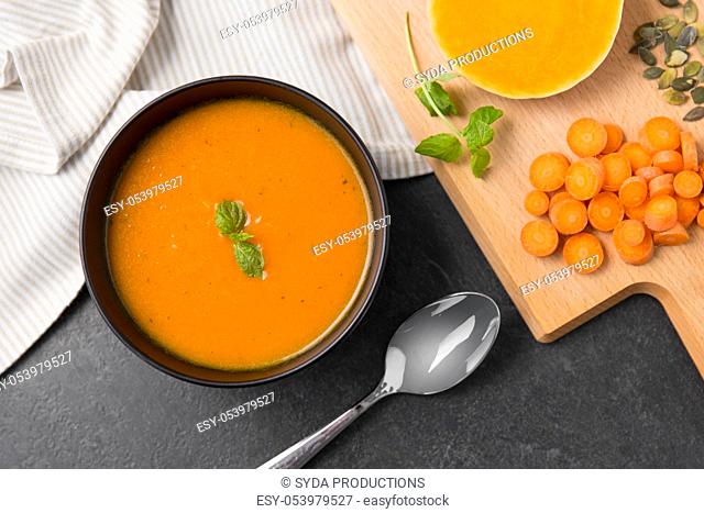 vegetable pumpkin cream soup in bowl with spoon