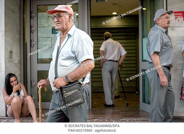 People wait outside a bank in Athens, Greece, 20 July 2015. Greek banks reopened on July 20 after a shutdown lasting three weeks but many restrictions on...