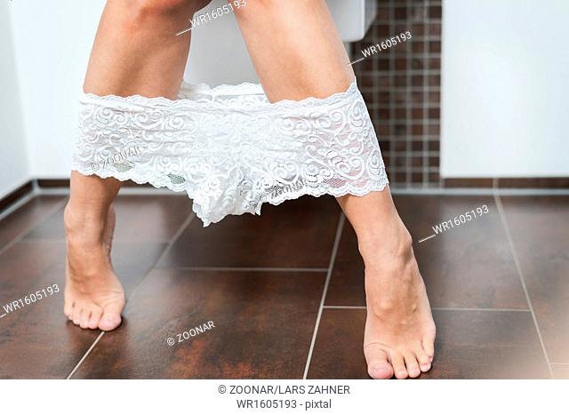 Woman with her panties around her ankles