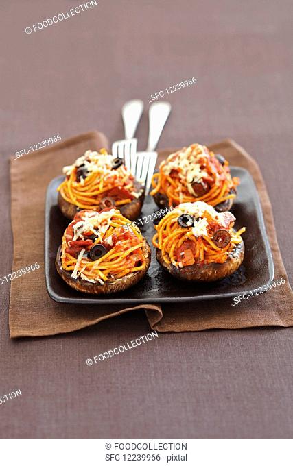 Baked portobello mushrooms stuffed with spaghetti with chorizo and black olives