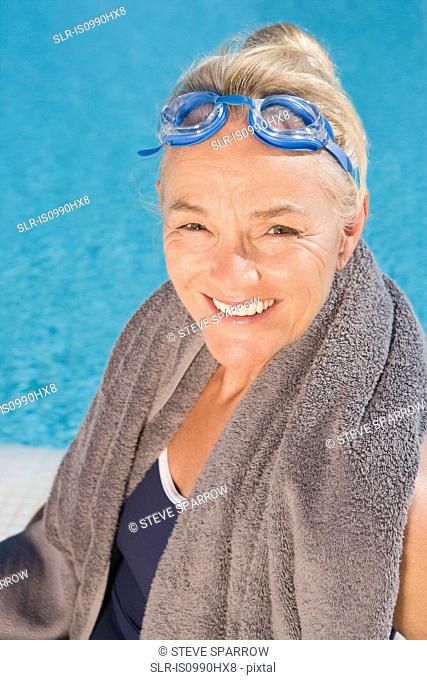 Mature woman by swimming pool