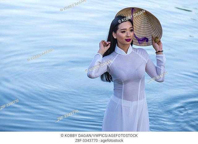 Vietnamese woman wearing Ao Dai dress during the Mid autumn festiaval in Hoi An Vietnam
