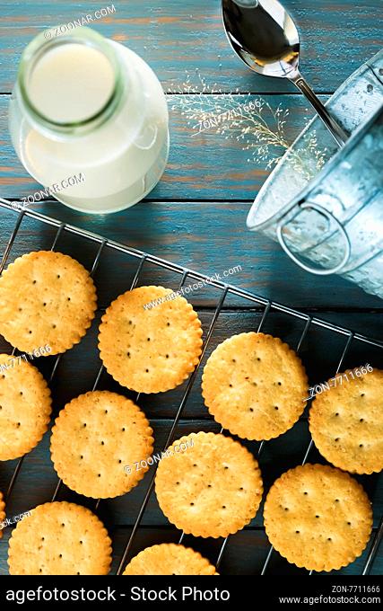 Delicious biscuits with milk on a wooden table