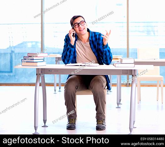 Student studying in the empty library with book preparing for exam