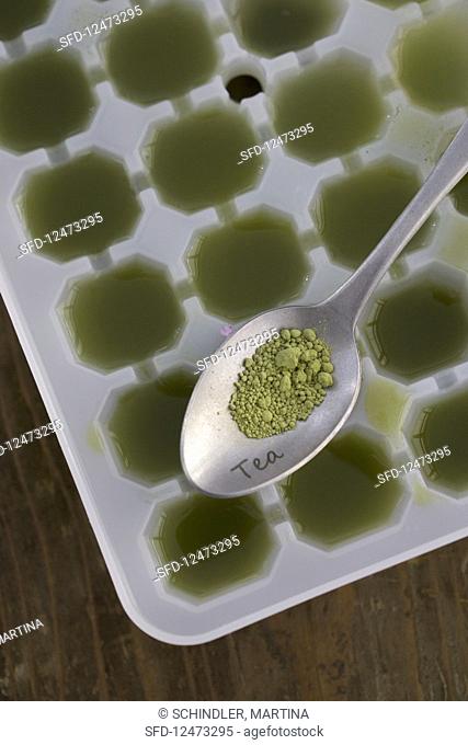 Ice cubes being made from matcha tea