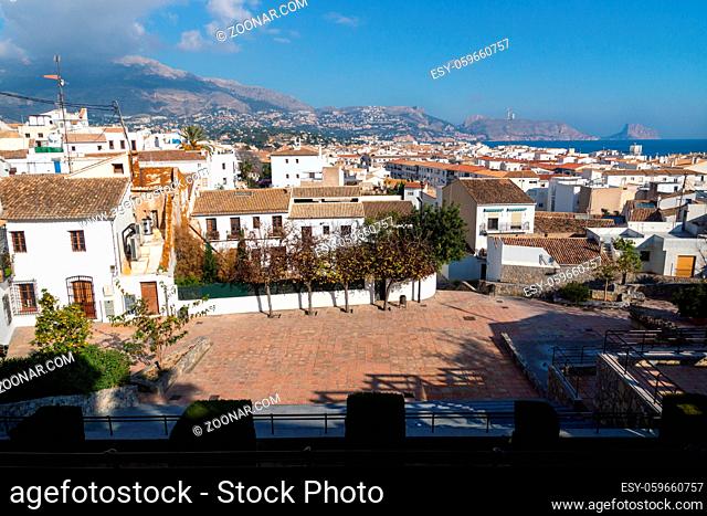 Outlook at the old town square Placa l'Aigua with sunny view over skyline and ocean with mountains, Altea, Costa Blanca, Spain