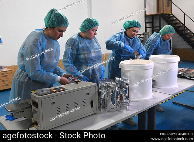 Women fill bags by dried potatoes, left, and dried juice with meat, right, in a packing operation at the Freeze Dry Company