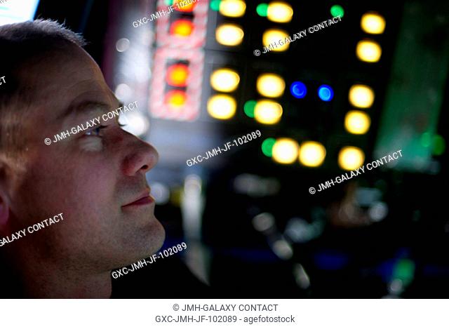 Inside the International Space Station's Cupola, Expedition 34 Flight Engineer Tom Marshburn assists fellow crew members (out of frame) during capture and...