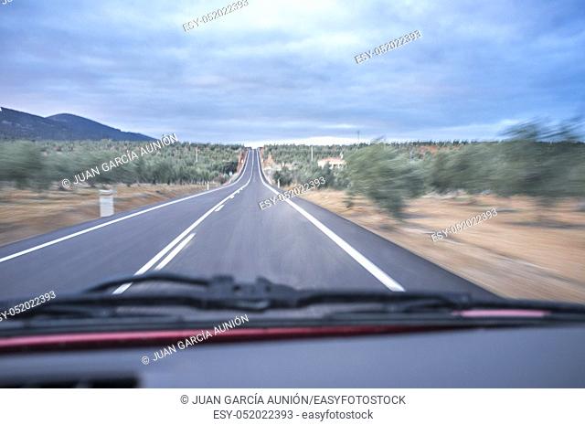 Driving along olive trees fileds of South Spain. Motion blurred shot