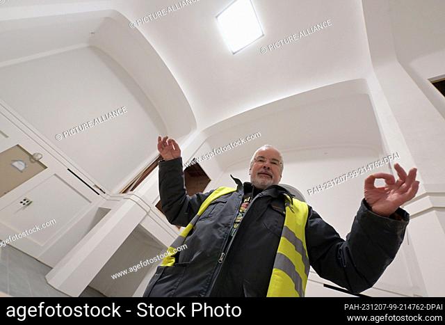 PRODUCTION - 06 December 2023, Brandenburg, Potsdam: Wieland Eschenburg from the Garrison Church Foundation stands in front of the wall openings in the chapel...