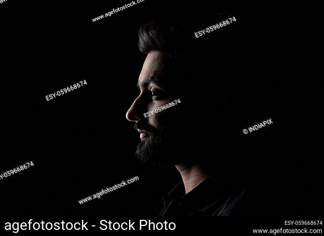 PORTRAIT OF A BEARDED MAN LOOKING STRAIGHT