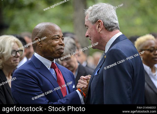 Mayor Eric Adams (Democrat of New York, New York), left, and Governor Phil Murphy (Democrat of New Jersey) shake hands during a commemoration ceremony at the...