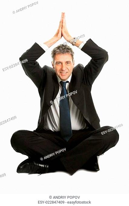 Businessman sitting in yoga position