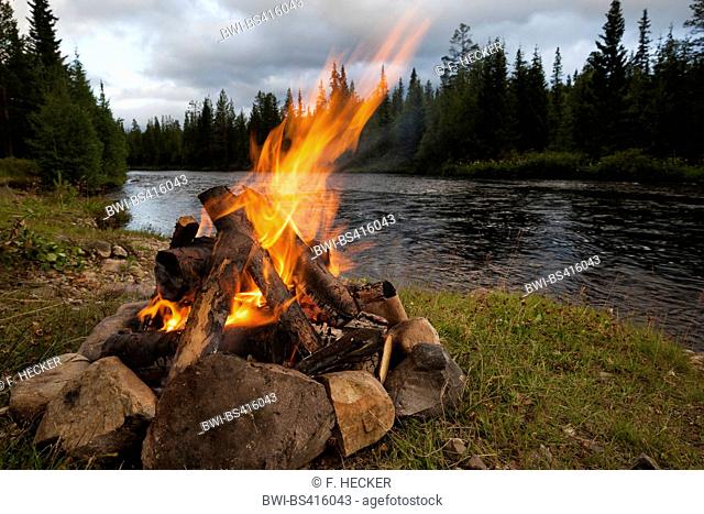 bonfire on riverbank, Sweden