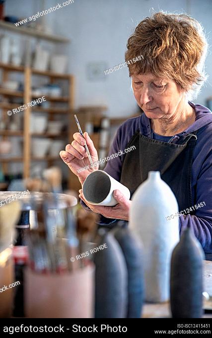 Spain, Baleares, Woman painting ceramics in workshop