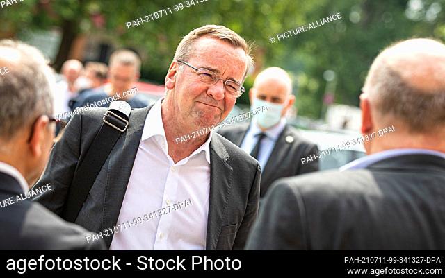 11 July 2021, Lower Saxony, Hanover: Boris Pistorius (M, SPD), Interior Minister of Lower Saxony, discusses with trade union representatives demonstrating at...